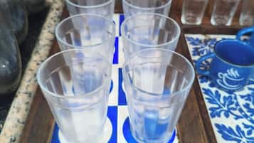 A tray with multiple clear plastic cups arranged on a blue and white patterned surface.