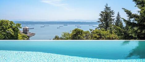 Une piscine d’eau cristalline, d’un bleu éclatant, d’où l’on peut admirer l’océan et les navires qui voguent au loin.