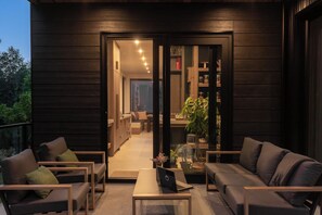 A modern interior with a dining area, a seating area with sofas and a coffee table, and a visible kitchen. - 3BR Sea-to-Sky Retreat with Rec Room, Near Creek (Britannia Beach)