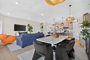 A modern living space with a dining area, kitchen, and seating arrangements. - Lakefront Retreat at Table Rock Lake (Kimberling City)