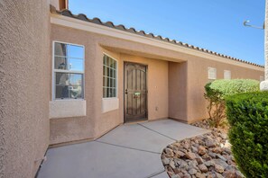 A residential building with a stucco exterior, a metal door, and a small window. - GEM/3BD/flex office space/sleeps 6/private 2 car garage/20 min strip & airport, (Las Vegas)