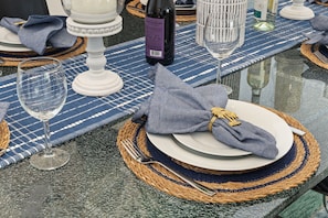 A table set with a white plate, a folded napkin, a fork, and a wine glass. - Waterfront | Boat Rental | Heated Pool | Game Rm | Gym (Lighthouse Point)