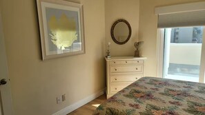 A bedroom with a bed, a dresser, a mirror, and a framed picture on the wall. - Amazing 2 /2 Beachside Get Away w/Nice Ocean View! (Cape Canaveral)