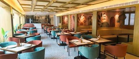 A restaurant with multiple seating areas, including booths and tables.
