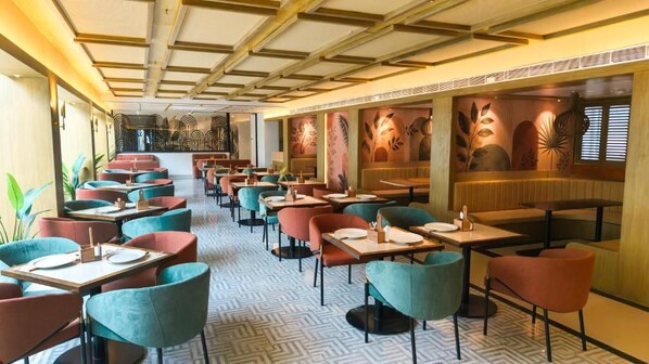 A restaurant with multiple seating areas, including booths and tables.