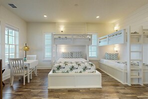 A bedroom with bunk beds, a desk, and a chair. - Real Good Tan | Golf Views | Steps to Beach (Port Aransas)