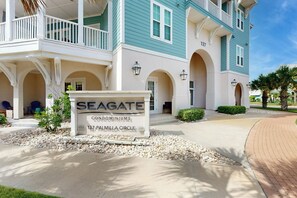 A condominium building with a sign indicating 'SEAGATE CONDOMINIUMS 137 PALMILLA CIRCLE.' - Resort Views | Private Patio | Beach Escape (Port Aransas)