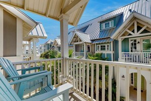 A coastal residential area with multiple houses featuring gabled roofs and white railings. - Third Coast Charm | Pool Steps Away | Balconies (Port Aransas)