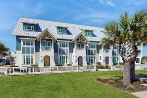 A multi-story building with a symmetrical facade, multiple windows, and a central entrance. - Palmilla Beach CocoLoco| Gulf Views | Resort Perks (Port Aransas)