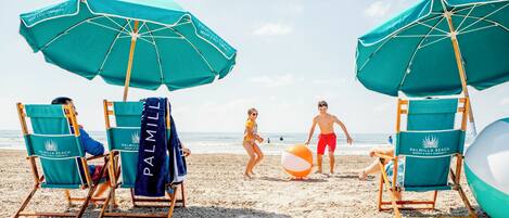 A beach scene with beach chairs and umbrellas at Palmilla Beach Resort & Golf Community.