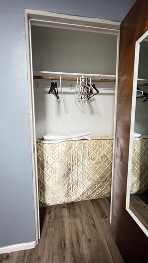 A bathroom with a wooden floor, a sink with a patterned countertop, and a mirror. - Charming 2-bedroom apartment with AC in beautiful Fargo (Fargo)