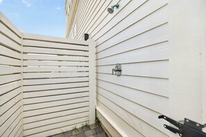 A white exterior wall with a metal gate and a metal door handle. - Sunset Hacienda | Water Views | Steps to Beach (Port Aransas)