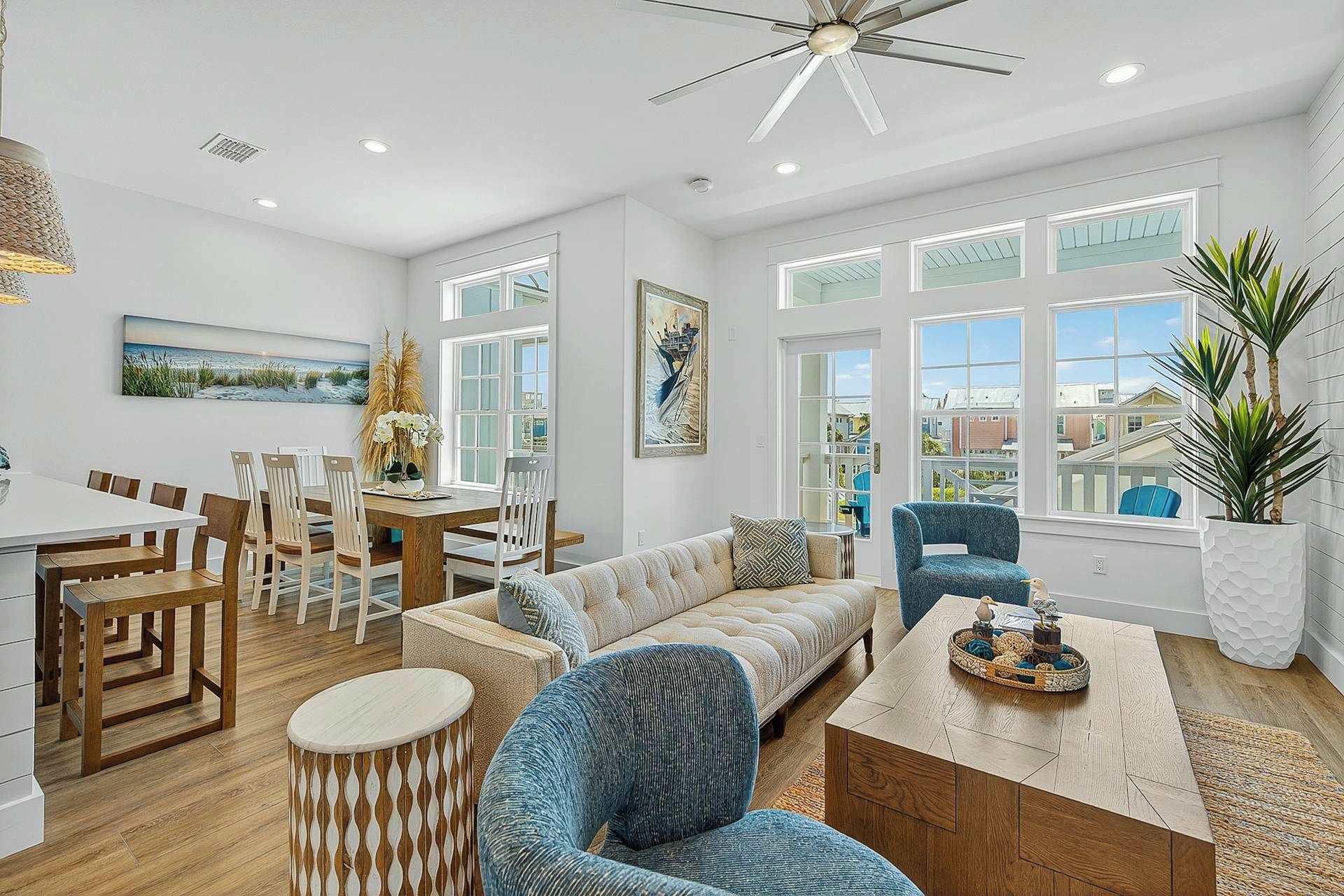 A spacious living area with a dining table, chairs, a sofa, and a coffee table.