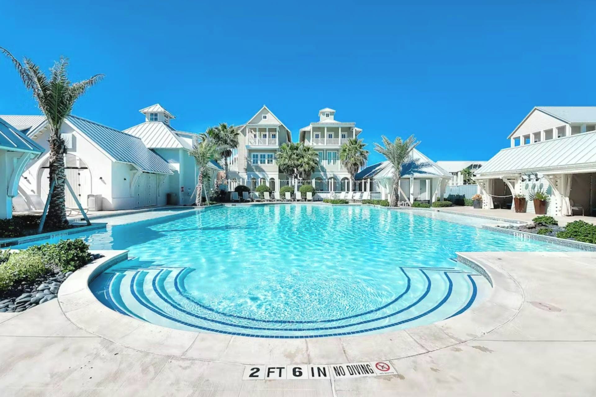 A large swimming pool with a 2 ft 6 in depth marker and a no diving sign.