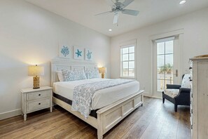 A bedroom with a bed, bedside tables, a chair, and artwork on the wall. - The Sandcastle | Gulf Views | Private Elevatorv (Port Aransas)