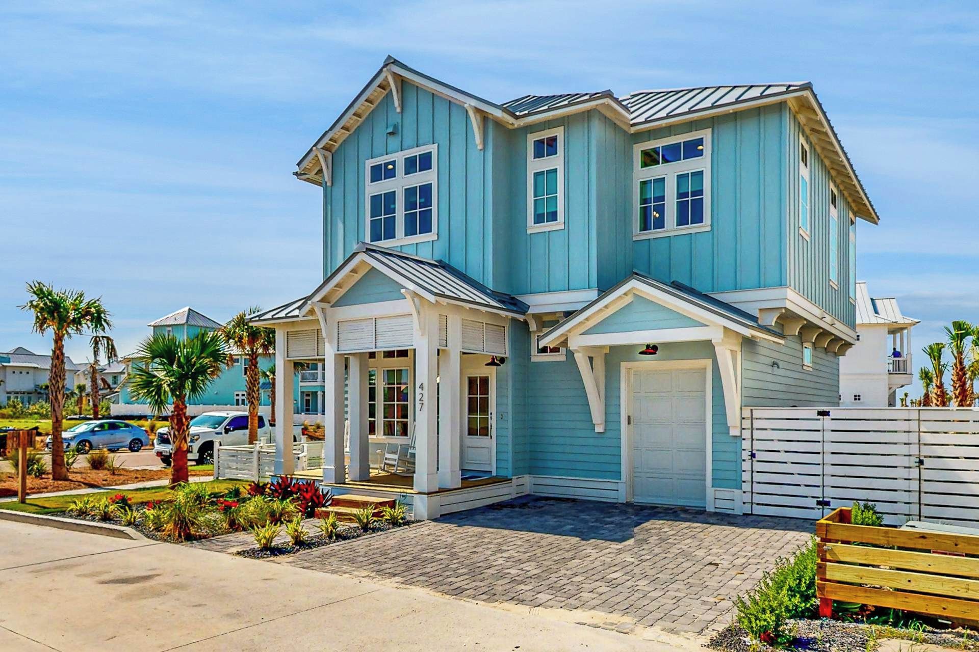 A two-story house with a garage, a covered porch, and a small deck.
