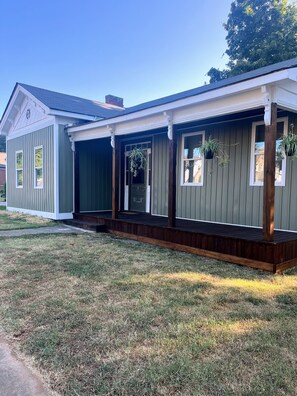 A residential building with a covered porch, a front door, and windows. - This historic home is close to everything! Walking distance to downtown Florence (Florence)