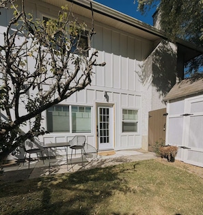 A residential building with a covered patio area, a door, and a window. - Cozy Saanich 1 BR Suite | Private Patio & Yard (Victoria)
