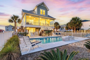 A two-story house with a swimming pool, outdoor seating, and a fenced yard. - Luxury Beach House 50 Steps To Beach / Heated Pool (Gulf Shores)