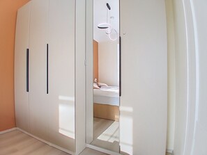 A room with a wardrobe, a bed, and a mirror. - BUKY Escape by Interhome (Mladé Buky)