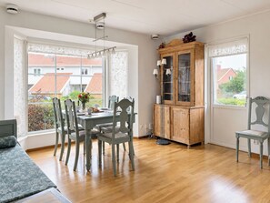 A dining area with a table, chairs, and a cabinet. - Cityhuset by Interhome (Falkenberg)