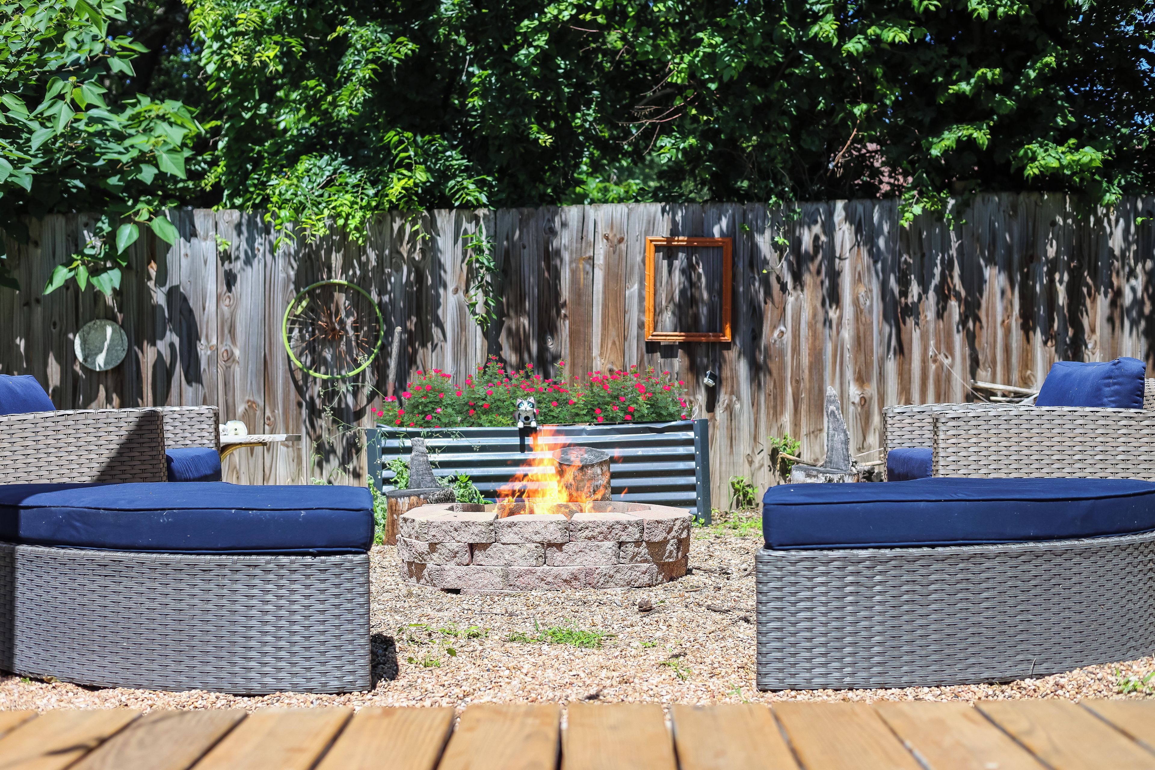 A patio with wicker furniture and a fire pit.