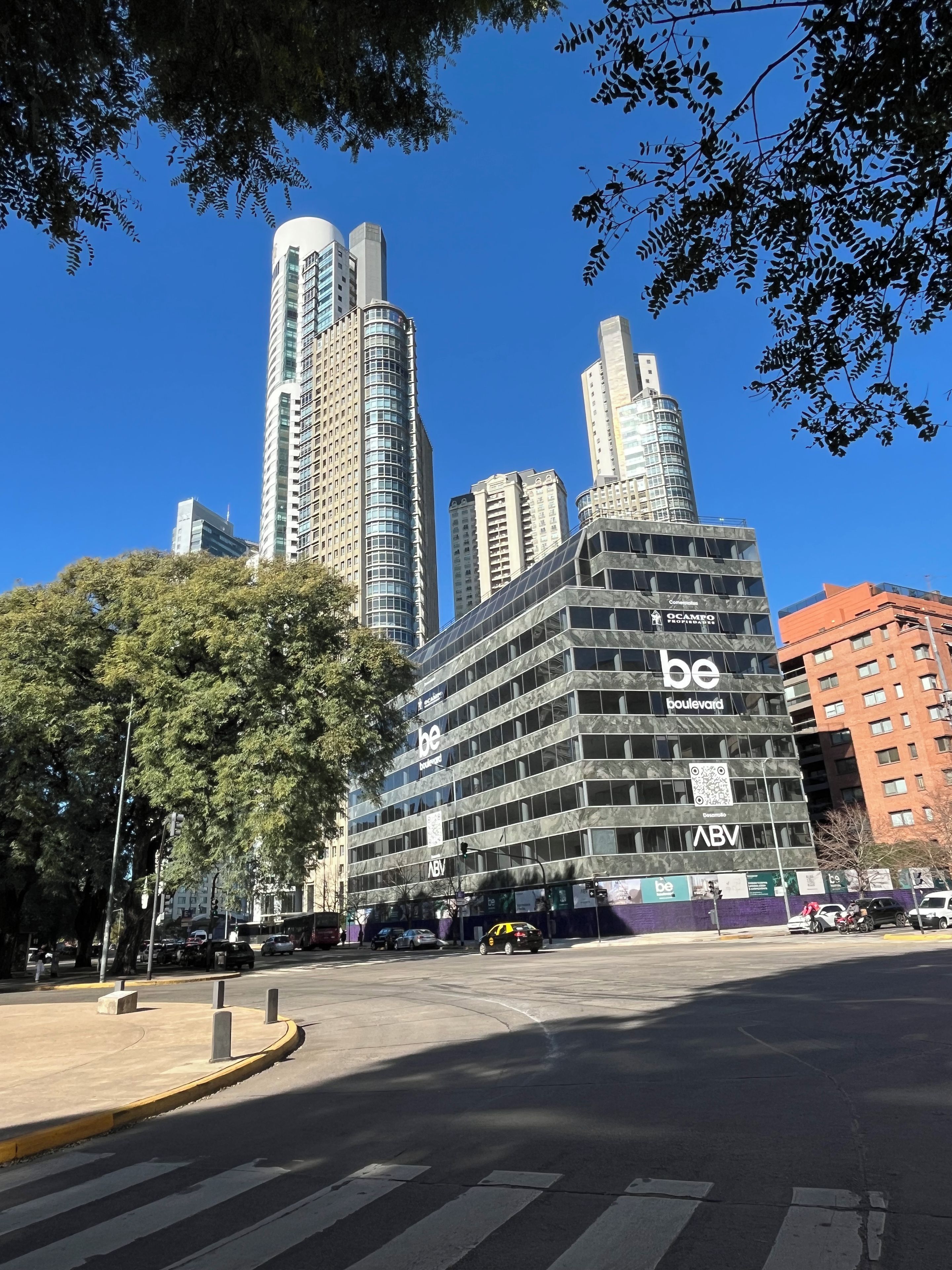 A modern building with multiple floors, large windows, and a prominent 'be boulevard' sign.