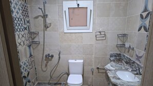 A bathroom with a toilet, shower, and sink. - Apartment in New Alamein
Furnished Apartment for Rent in Downtown New Alamein (Marsa Matrouh Governorate)
