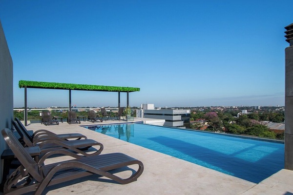 Building rooftop pool with loungers