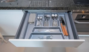 A kitchen drawer with utensils and a knife. - Work Ready Hub with Gym, Pool&Shopping in Mariscal (Asunción)