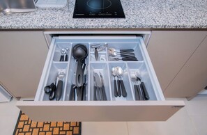 A kitchen drawer with various utensils neatly organized. - Modern 1BR | Rooftop Pool, Coworking & City Views (Fernando de la Mora)