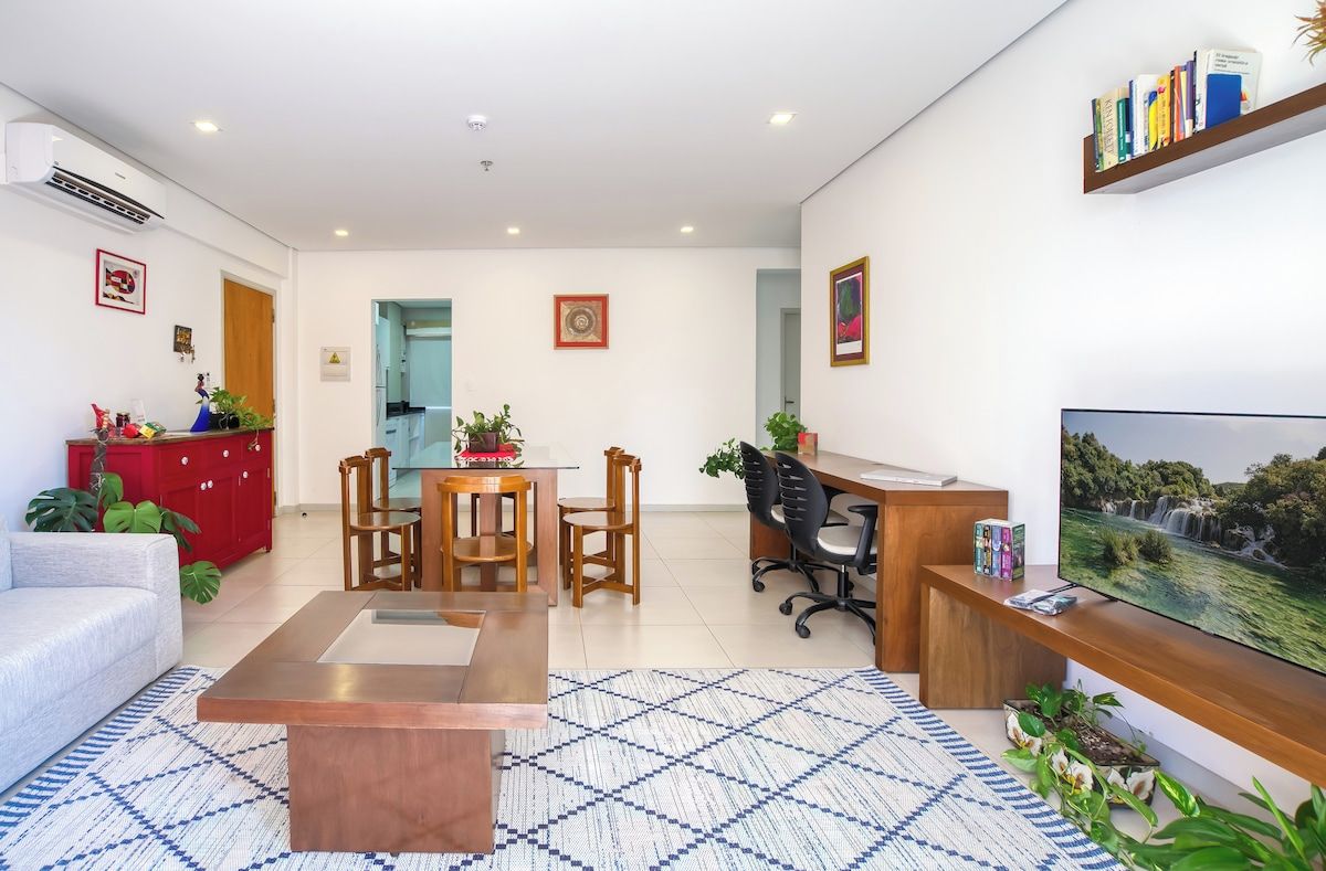Bright living and dining area with TV