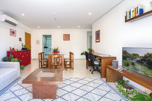 Bright living and dining area with TV