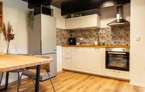 A kitchen with white cabinets, a wooden countertop, a built-in oven, and a patterned backsplash. - Beautiful home in Zabok with private swimming pool, can be inside or outside (Zabok)