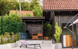 A patio with a grill, outdoor furniture, and a wooden structure with a tiled roof. - Beautiful home in Zabok with private swimming pool, can be inside or outside (Zabok)