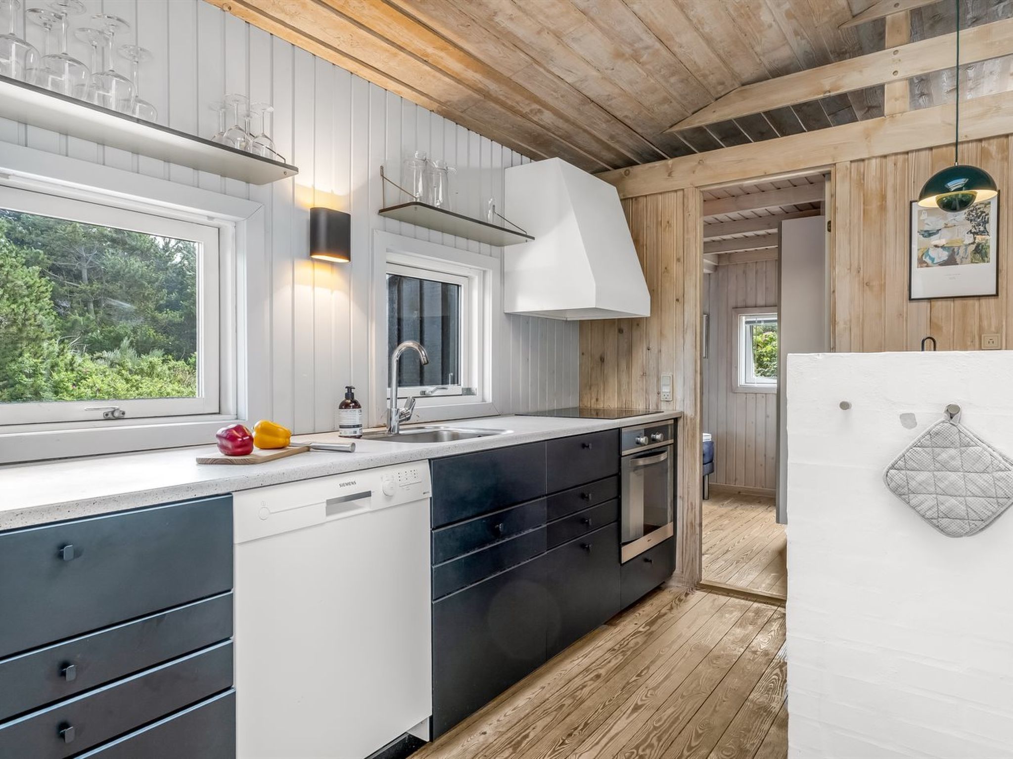 A modern kitchen with a built-in dishwasher, a sink, and a stove.