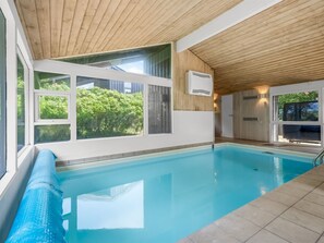 A swimming pool with a wooden ceiling and large windows. - "Senija" - 100m from the sea by Interhome (Fjerritslev)