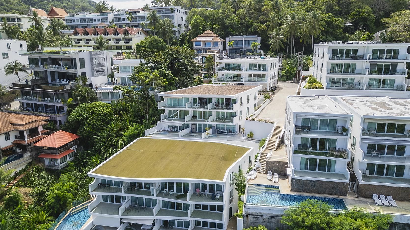 A multi-story residential building with a rooftop pool and a staircase leading to the upper levels.