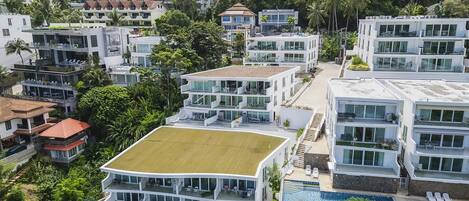 A multi-story residential building with a rooftop pool and a staircase leading to the upper levels.