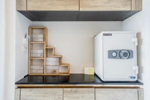 A kitchen with a white refrigerator, wooden cabinets, and a built-in wooden shelf with storage boxes. - Best Seaview 1 Bed Condo Sky Garden Rawai Beach (Rawai)