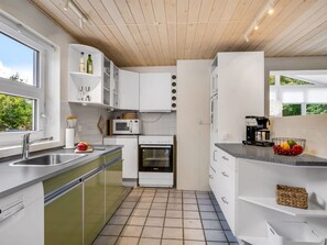A modern kitchen with a built-in oven, a sink, and a window. - "Helemine" - 800m from the sea by Interhome (Blokhus)