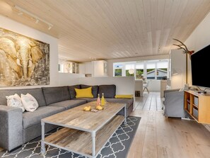 A modern living room with a grey sofa, a wooden coffee table, and a large painting on the wall. - "Helemine" - 800m from the sea by Interhome (Blokhus)