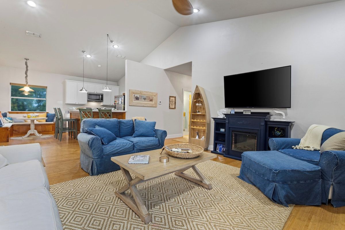 A modern living room with a sofa set, a coffee table, and a television.