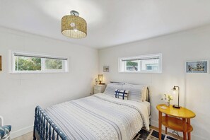 A bedroom with a bed, bedside tables, a lamp, and a window. - 2BR with amazing views, firepit (Bow)
