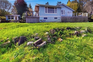 A house with a large front yard, a small shed, and a wooden deck. - 2 BR Waterfront home on Bainbridge Island (Bainbridge Island)