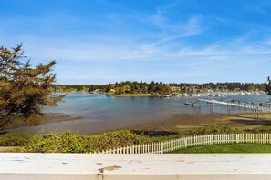 A waterfront property with a dock, a white picket fence, and a view of the water. - 2 BR Waterfront home on Bainbridge Island (Bainbridge Island)