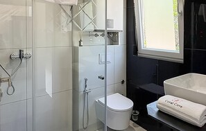 A modern bathroom with a glass shower enclosure, a white toilet, and a large sink with a towel labeled 'Coral Cove'. - Amazing home in Blato with private swimming pool, can be inside or outside (Blato)