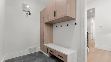 A modern bathroom with a shower, a toilet, and a sink.