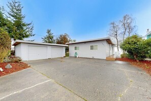 A residential property with two attached garages and a covered driveway.