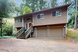 A two-story house with a front entrance, a staircase, and two attached garages. - Forest 3BR in Shoreline with patio & yard (Shoreline)
